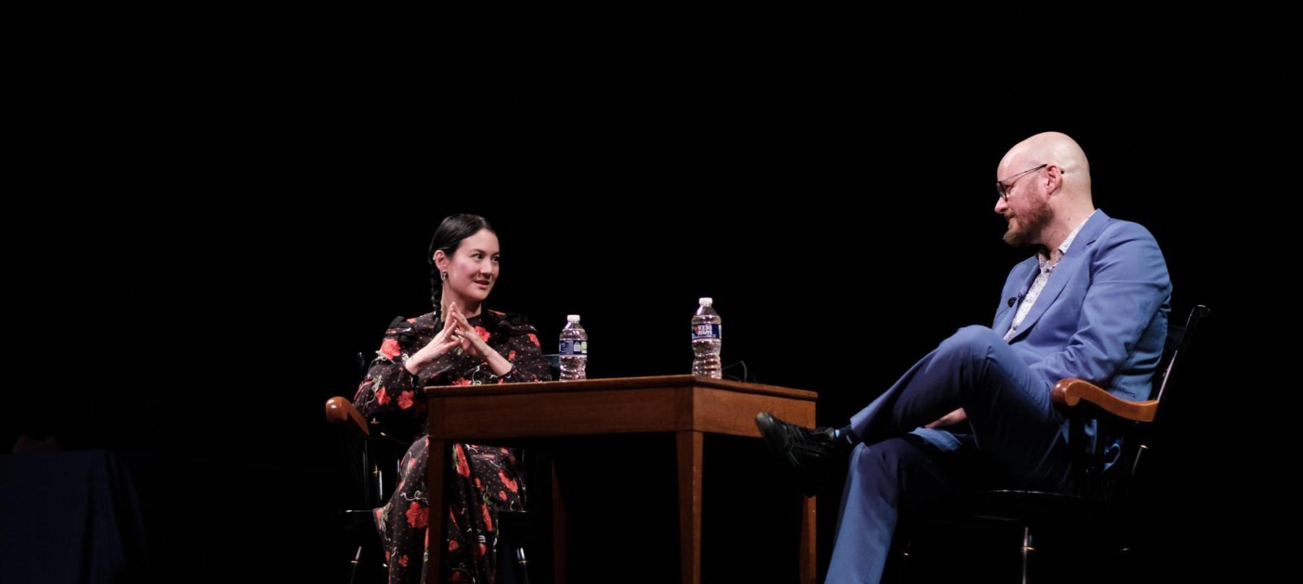 Michelle Zauner '11 (right) and Professor Daniel Torday on stage at Goodhart Hall.
